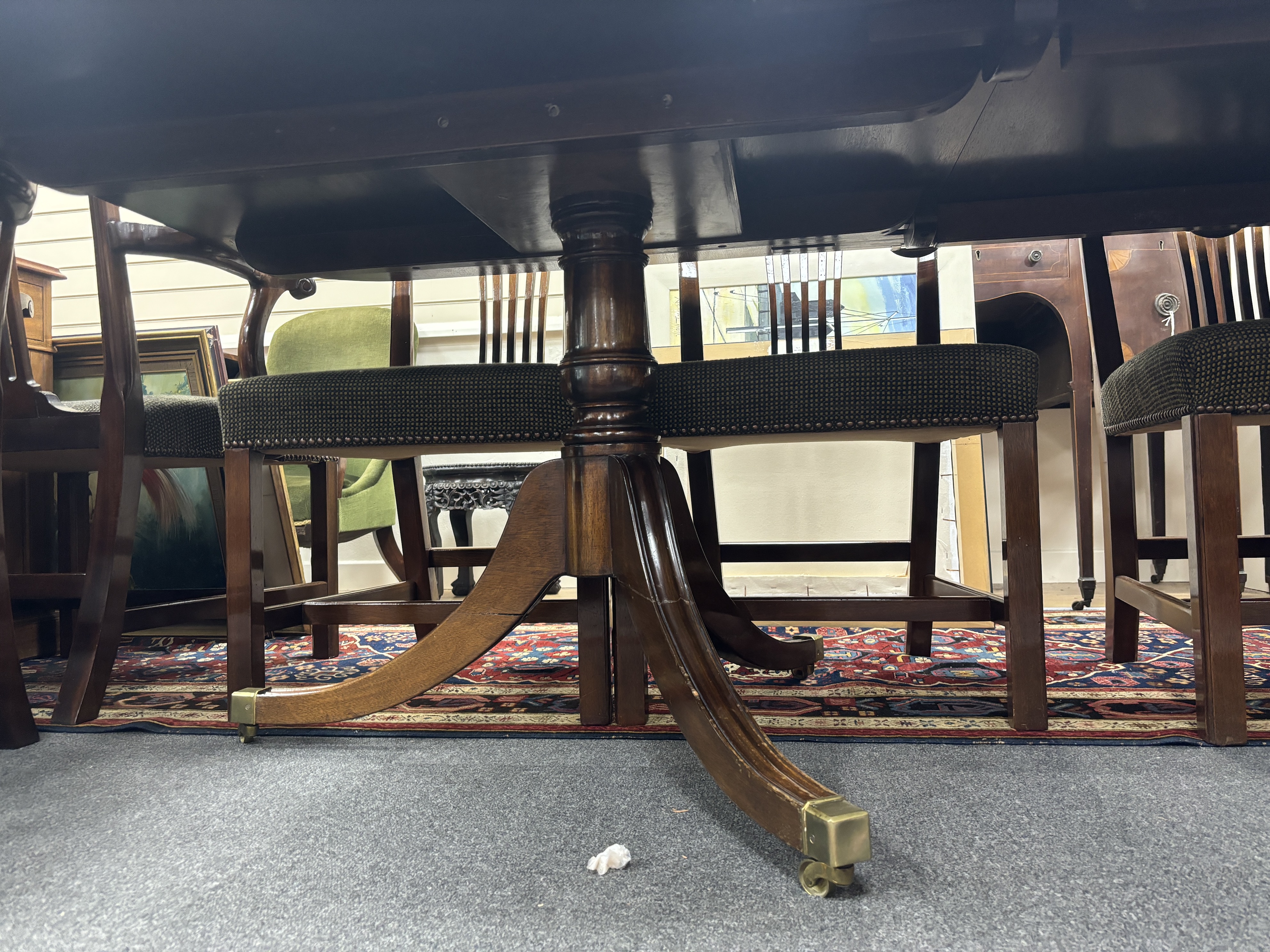 A reproduction George III style mahogany twin pillar extending dining table, 304cm extended, two spare leaves, depth 107cm, height 72cm